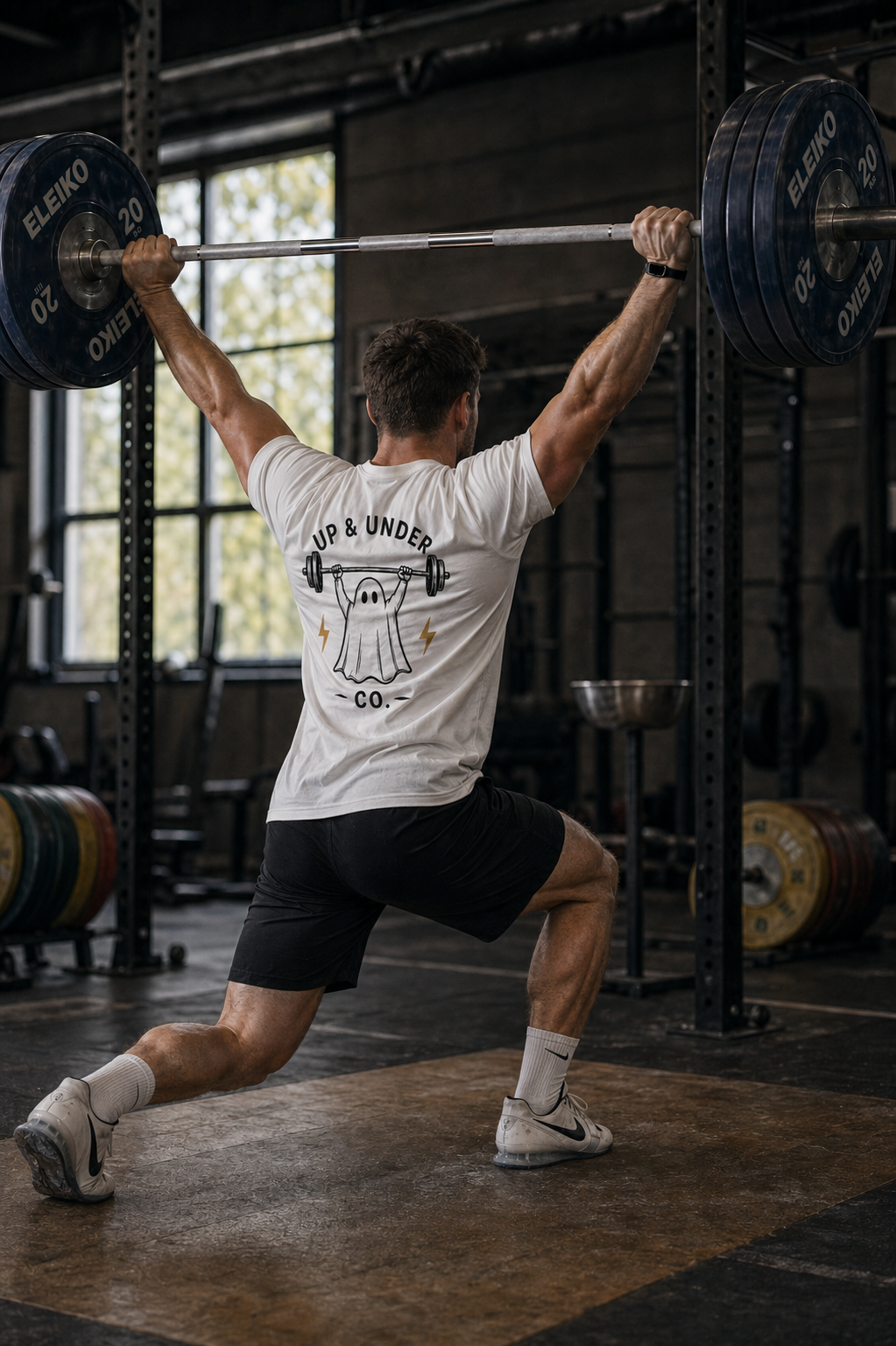 Weightlifter locking out a split jerk in the Ghost Tee