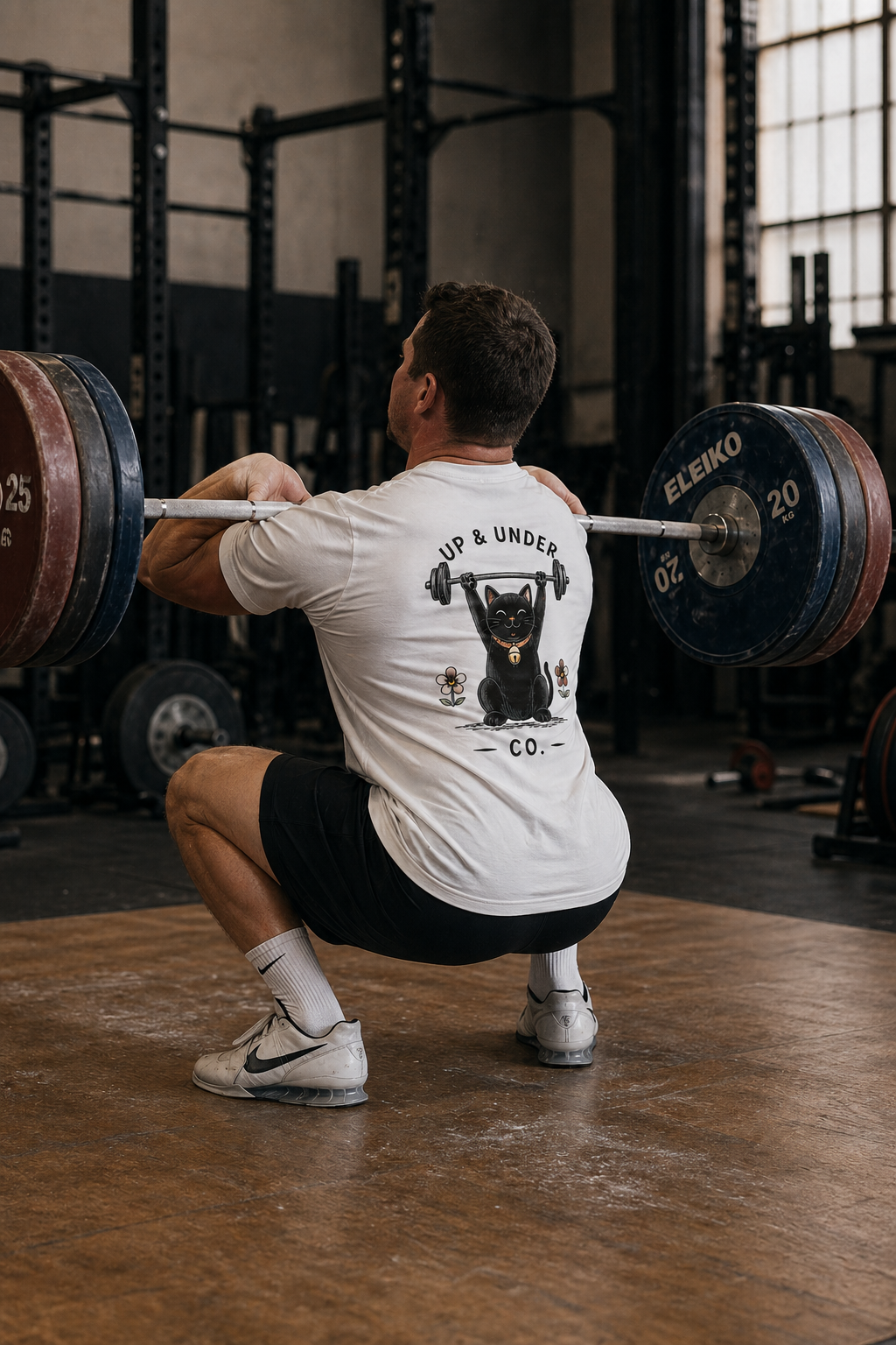 Weightlifter catching a clean in the Lucky Cat Tee