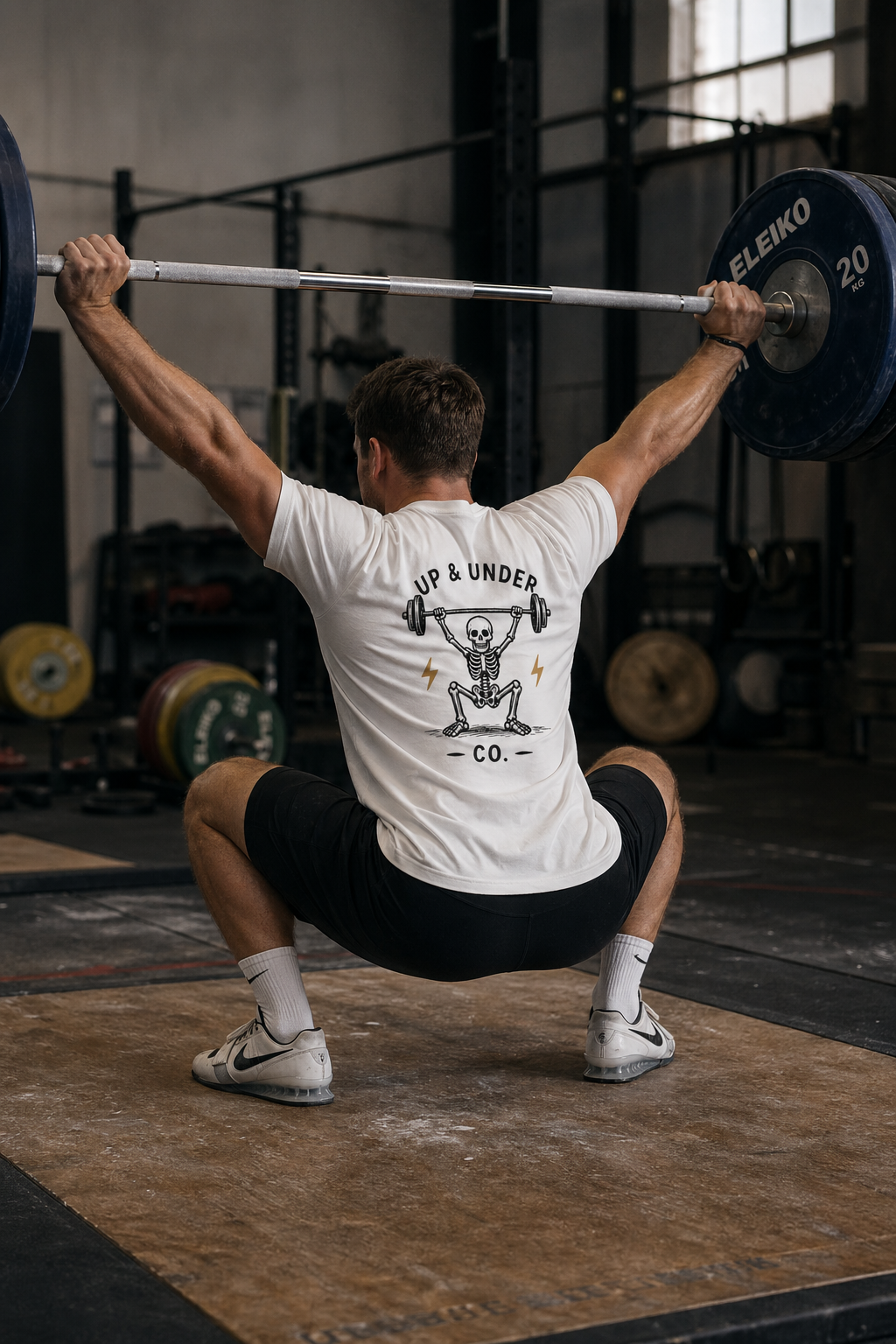 Weightlifter receiving a snatch in an Up & Under Co tee